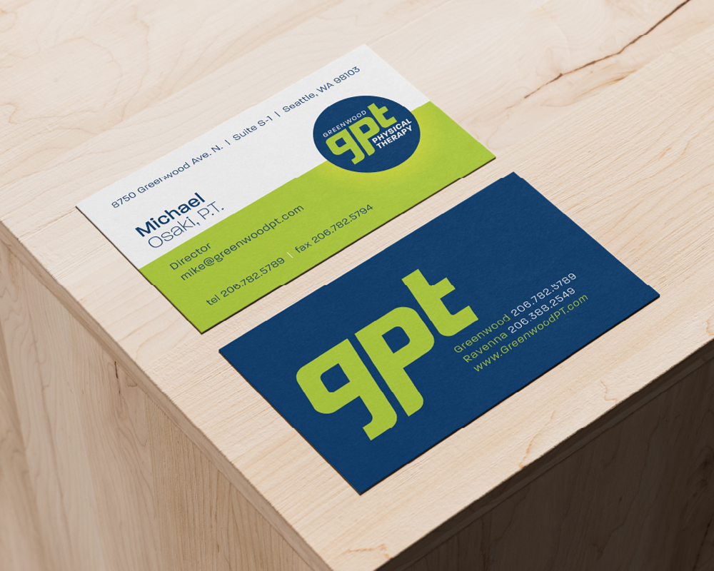 Greenwood Physical Therapy business card front and back shown from above