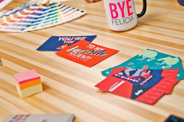 printed postcards and calendar pages sitting on table