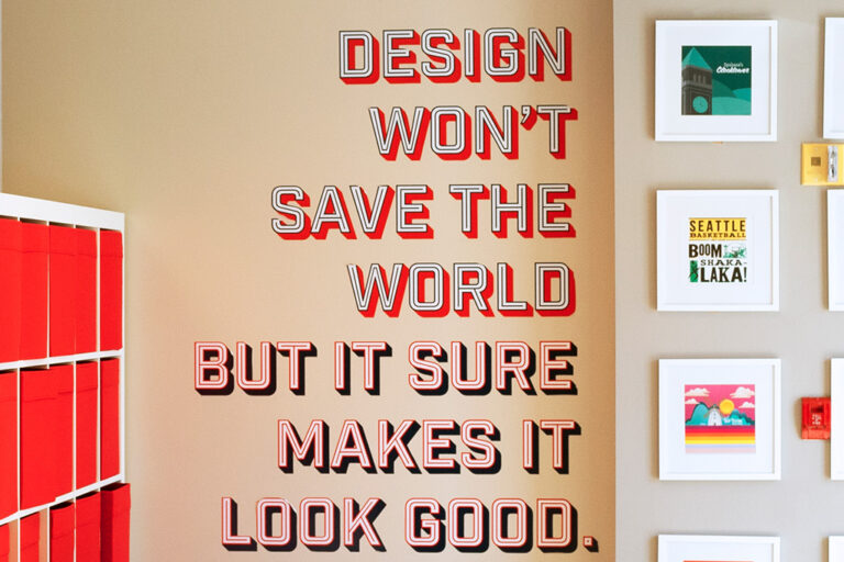 wall sign that says "design won't save the world but it sure makes it look good."