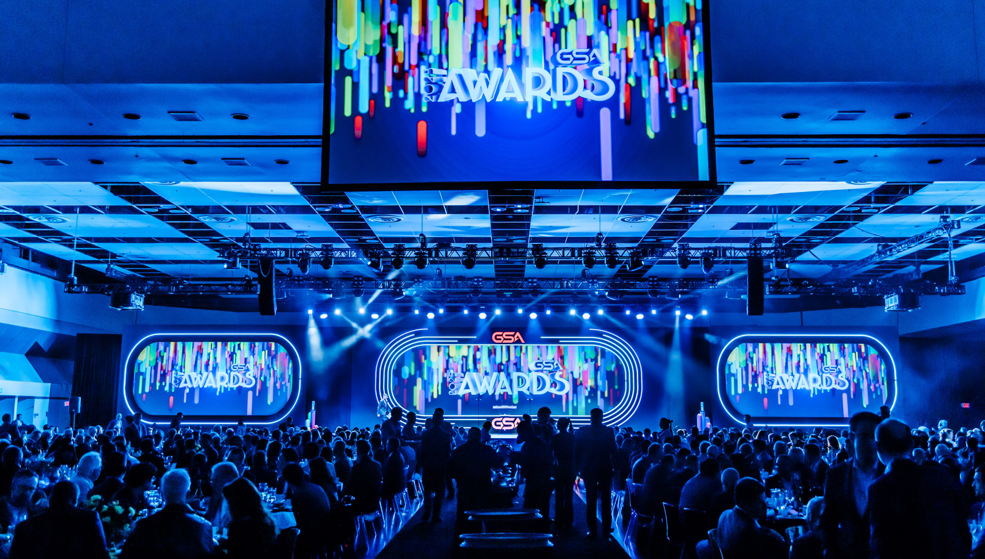 Event stage with the 2025 GSA Awards Celebration branding on a number of video screens